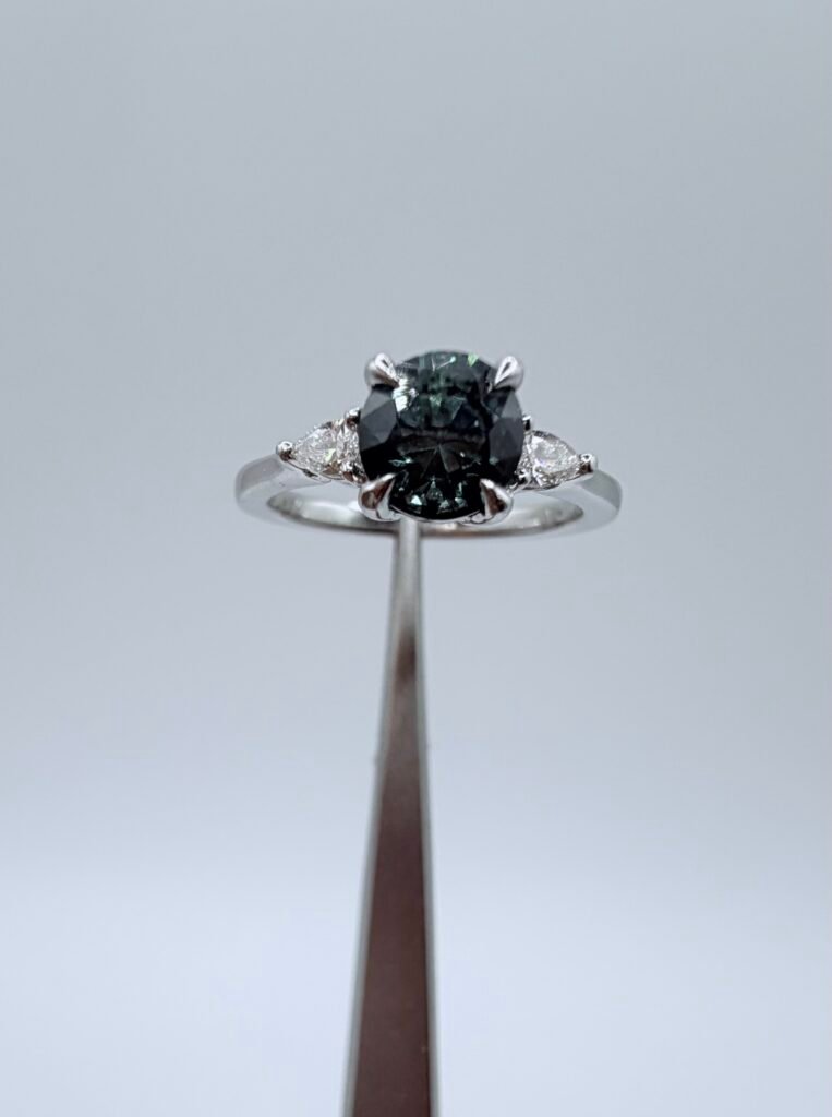 Irradiated Natural Blue Diamond and Platinum Three Stone Ring (.65 Carat Center Stone) .85 Estimated total carat weight